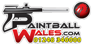 Paintball players taking cover during a game at Paintball Wales
