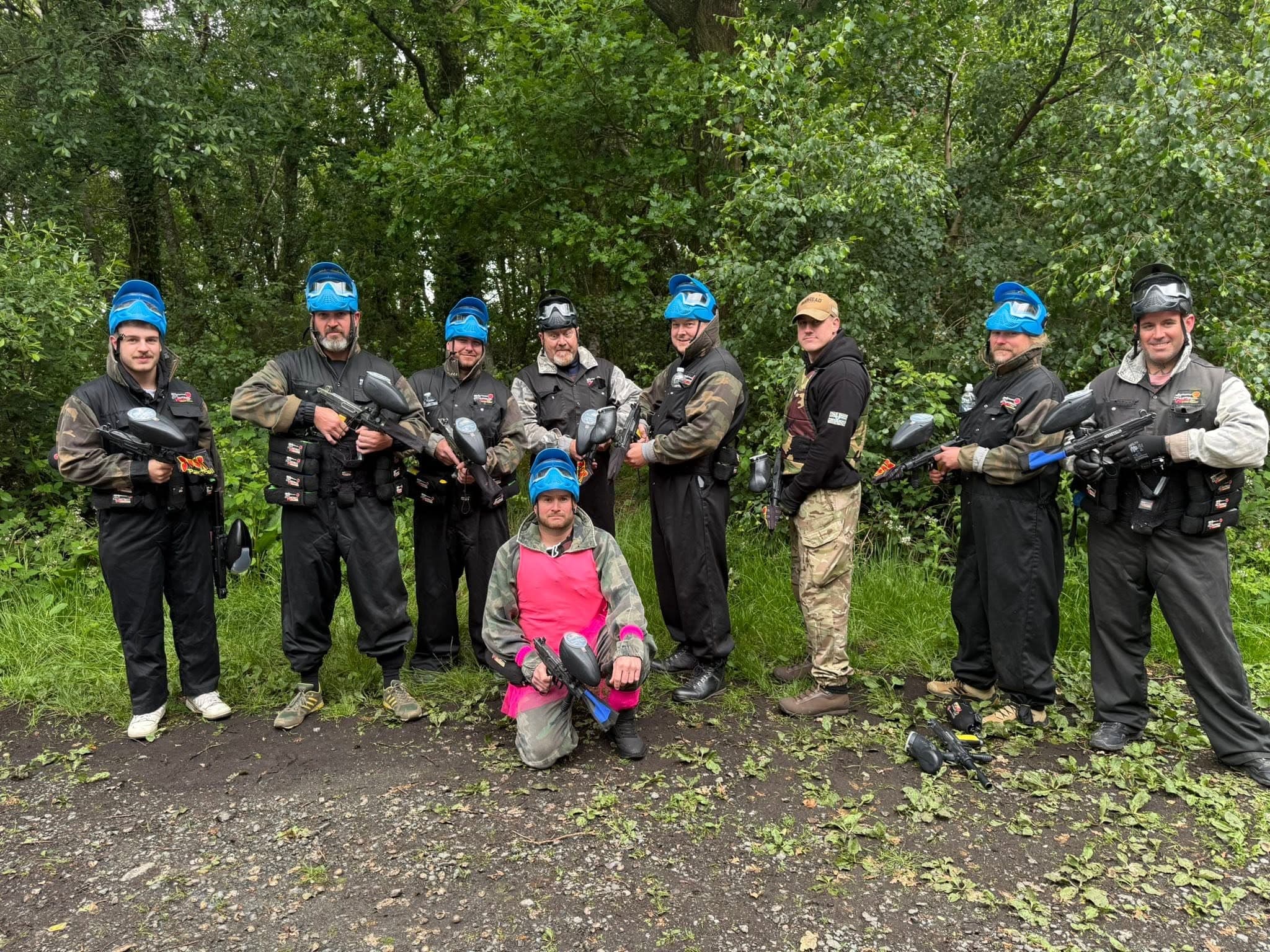 Stag group in fancy dress kitted up for paintball at Paintball Wales
